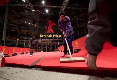 Workers fix red carpet in front of Berlinale Palace for upcoming 62nd Berlinale International Film Festival in Berlin