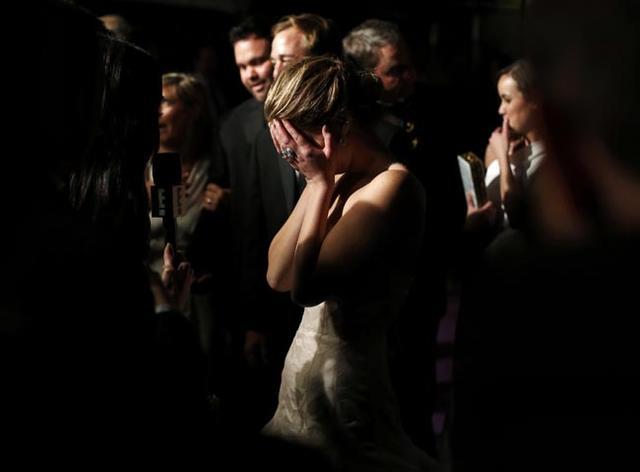 Lawrence, who won the Best Actress Oscar for "Silver Linings Playbook", reacts during an interview at the Governors Ball following the 85th Academy Awards in Hollywood
