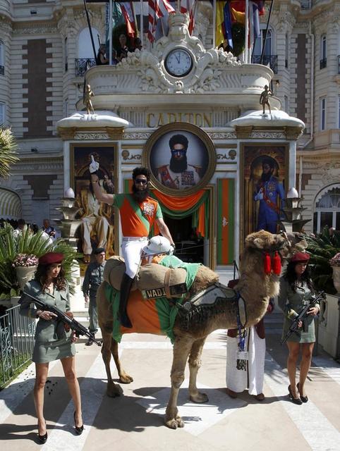 British actor Baron Cohen sits on a camel during a photocall on the Croisette in Cannes