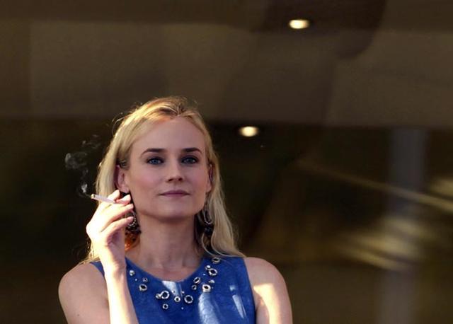 Diane Kruger smokes a cigarette on the terrace at the Martinez Hotel in Cannes on the eve of the opening of the 65th Cannes Film Festival