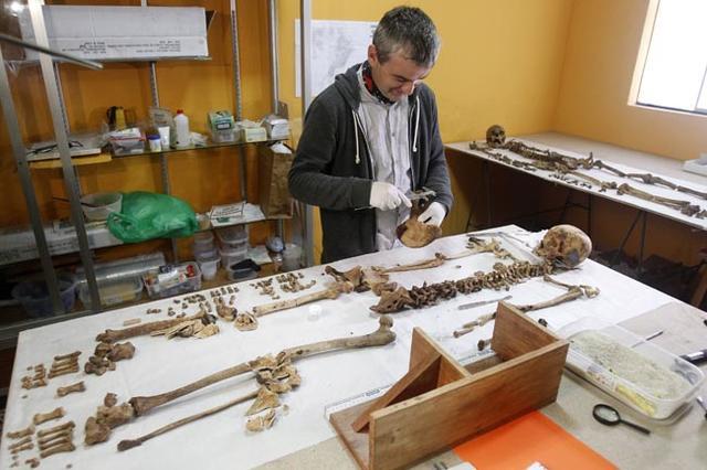 An archaeologist measures the remains found at a pyramid site called El Castillo de Huarmey